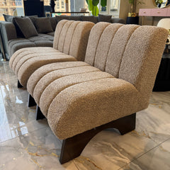 Beige textured sofa with wooden legs on a marble floor