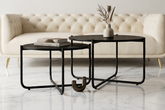 Modern living room with a cream sofa and black coffee tables.