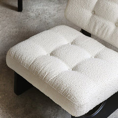 Close-up of a textured white cushion on a chair with a neutral background
