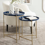 Two blue side tables with gold legs in a living room setting.