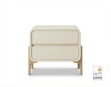 Modern white curved nightstand with two drawers and tapered natural wood legs, isolated on a clean white background.