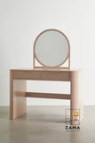 Isolated pink modern makeup vanity and dressing table with round mirror on a neutral studio background.