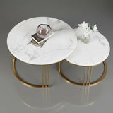 Two marble coffee tables with gold legs on a gray background