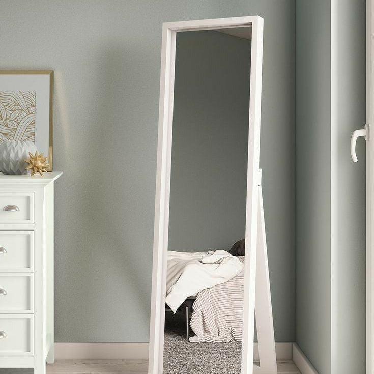 Full-length mirror standing against a wall in a room with a white dresser.
