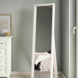 Full-length mirror standing against a wall in a room with a white dresser.