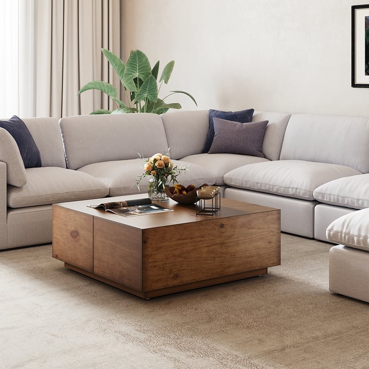 Modern living room with a sectional sofa and wooden coffee table.