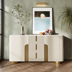 Modern sideboard with decorative items against a green wall