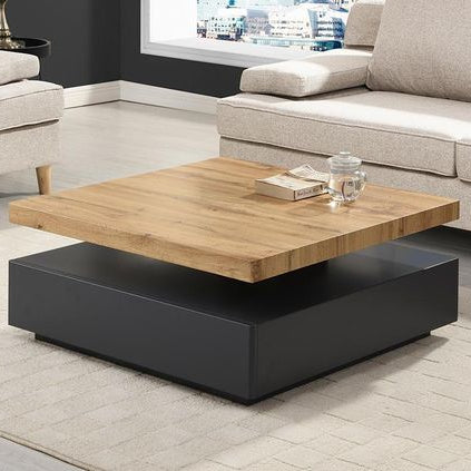 Modern coffee table with wooden top and black base in a living room setting.