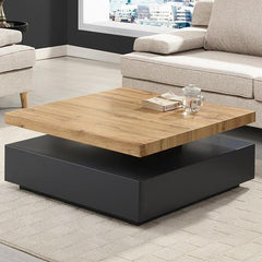 Modern coffee table with wooden top and black base in a living room setting.