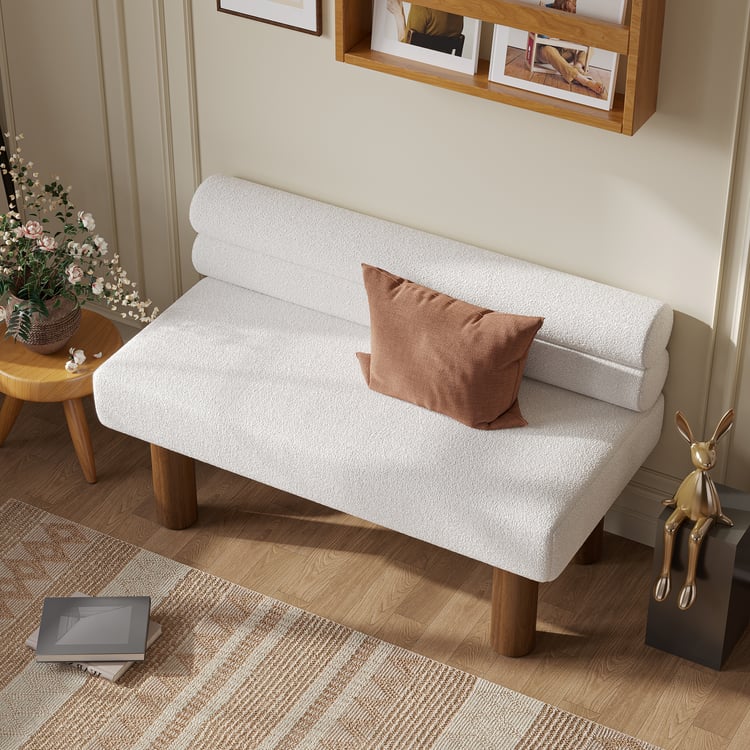 White sofa with a brown pillow in a living room setting