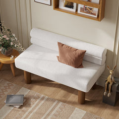 White sofa with a brown pillow in a living room setting