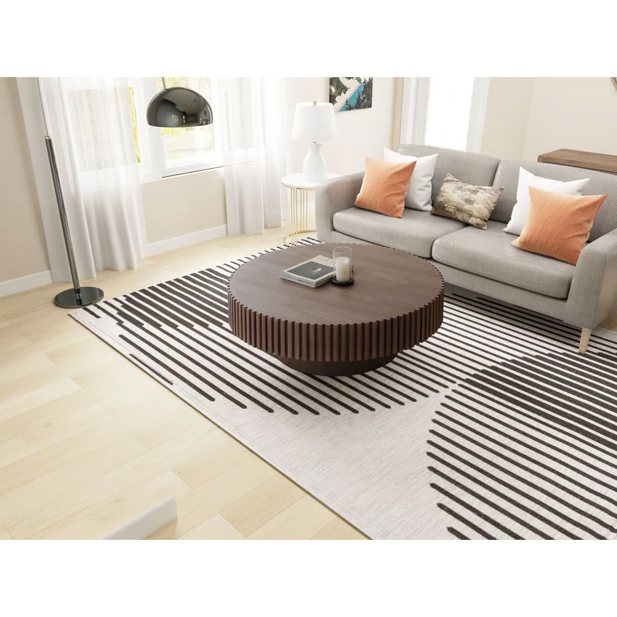 Modern living room with a gray sofa, wooden coffee table, and striped rug.