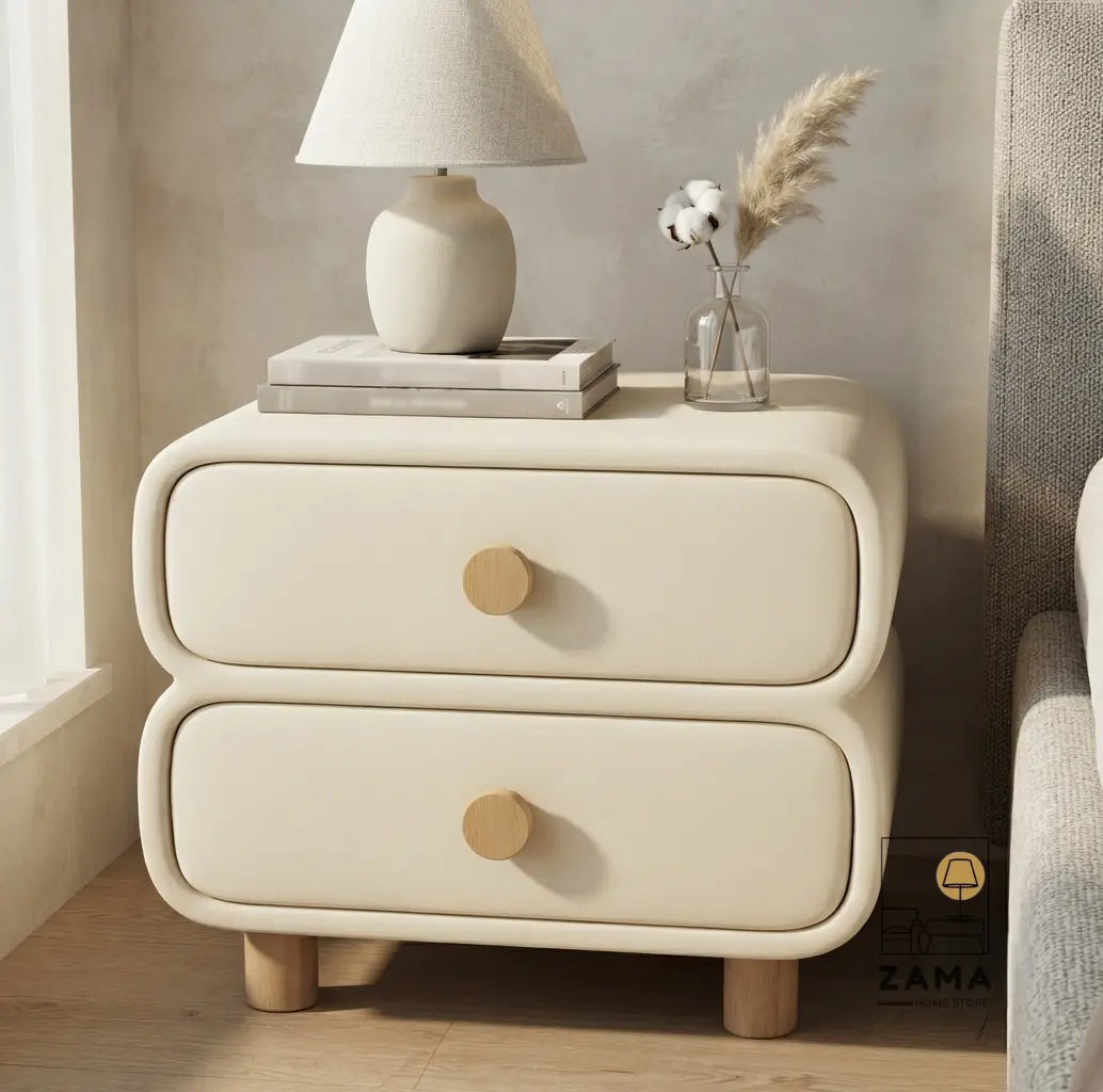 Modern cream upholstered nightstand positioned on the left side of a contemporary textured fabric bed in a luxury bedroom.