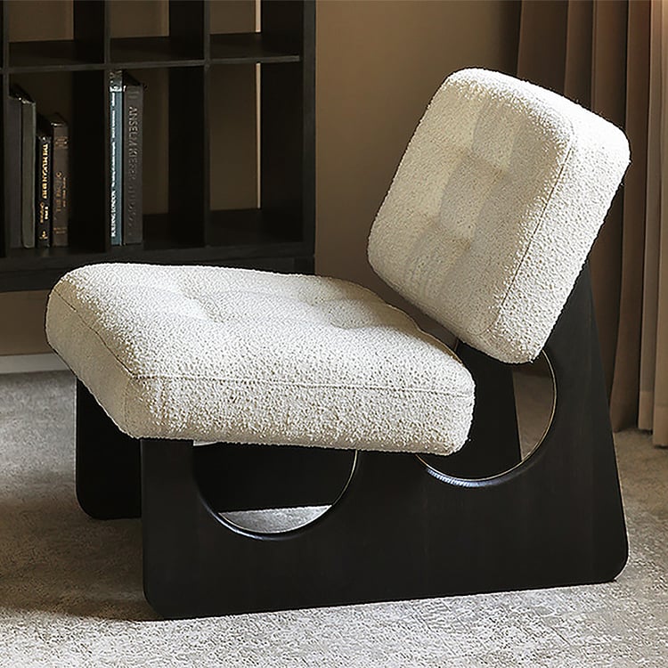 Modern chair with white textured seat and backrest in a room setting.