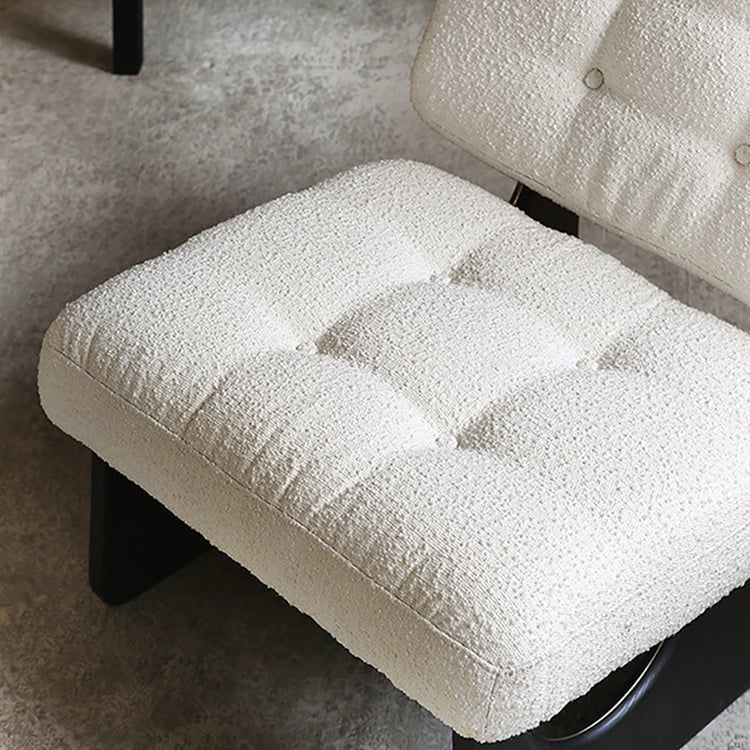 Close-up of a textured white cushion on a chair with a neutral background