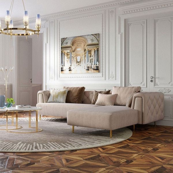 Modern living room with a beige sofa, decorative pillows, and a large painting on the wall.