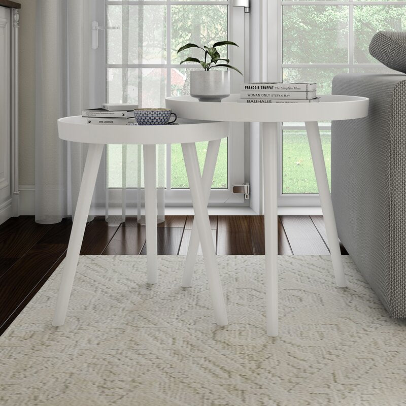 White side table with decorative items in a living room setting