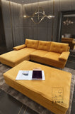 Mustard yellow velvet L-shape sectional sofa and matching ottoman with decor, from Zama Home Store.