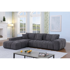 Gray sectional sofa in a living room with large windows and a fireplace.