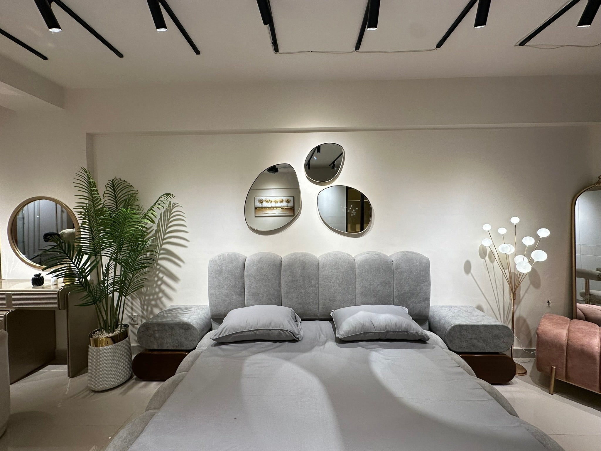 Decorative irregular pebble mirror wall-mounted in contemporary home interior