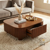 Modern wooden center table with fluted design, open storage drawer, and decor on a plush rug in a living room