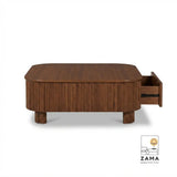 Studio product shot of a dark wood ribbed center table featuring a convenient sliding storage drawer against a white background