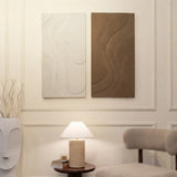 BOUCLE FLOW Wall Art hanging above a table lamp in a cozy neutral living room.