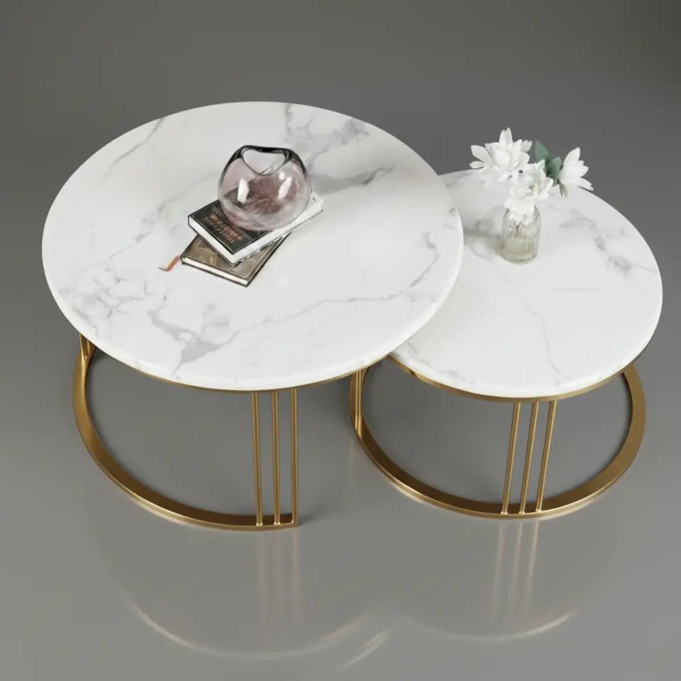 Two marble coffee tables with gold legs on a gray background