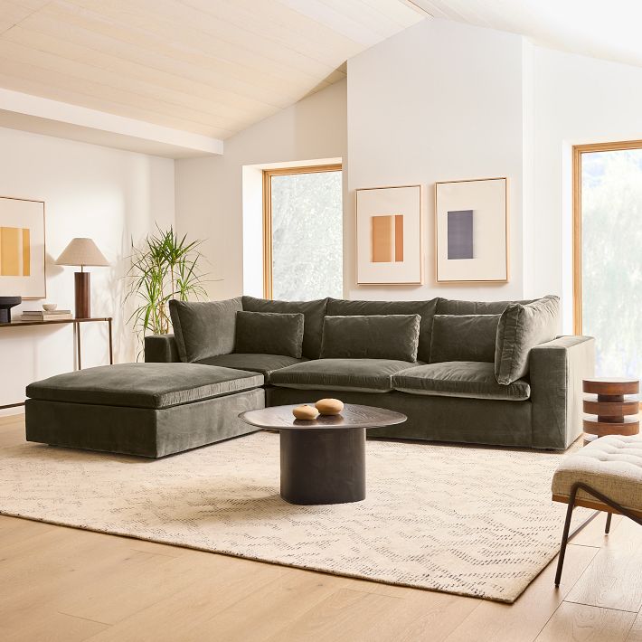 Modern living room with a gray sectional sofa, coffee table, and decorative elements.