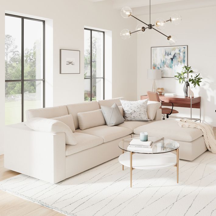 Modern living room with a beige sectional sofa, coffee table, and decorative elements.
