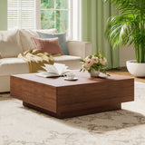 Living room with a wooden coffee table, book, cup, and flowers.
