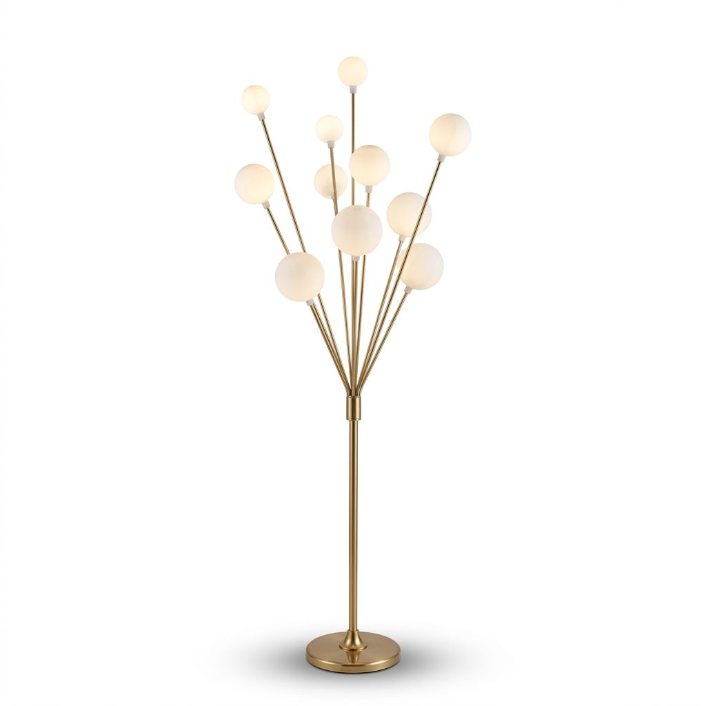 • Studio shot of a modern brass finish multi globe floor lamp on a clean white background.