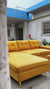 Video showcasing the custom mustard yellow velvet L-shape sofa with storage and matching ottoman by Zama Home Store, featuring fabric swatches and modern design details.