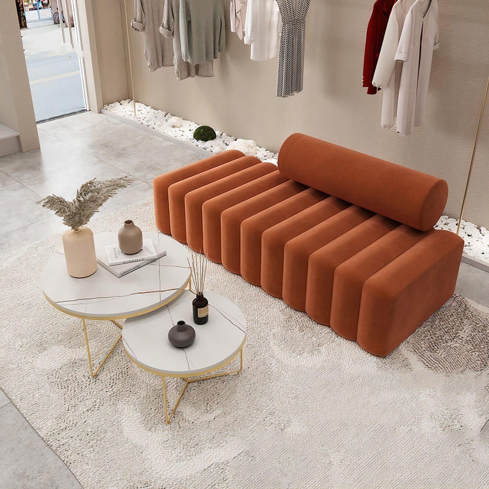 Modern orange sofa in a stylish room with decor elements.