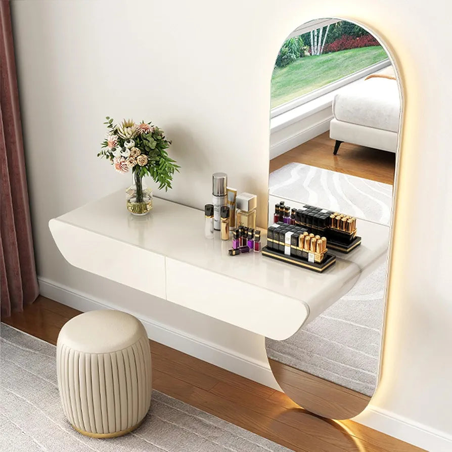 Modern vanity table with mirror, stool, and decorative items in a room.