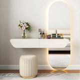 Modern vanity setup with a mirror, stool, and decorative items on a white wall.