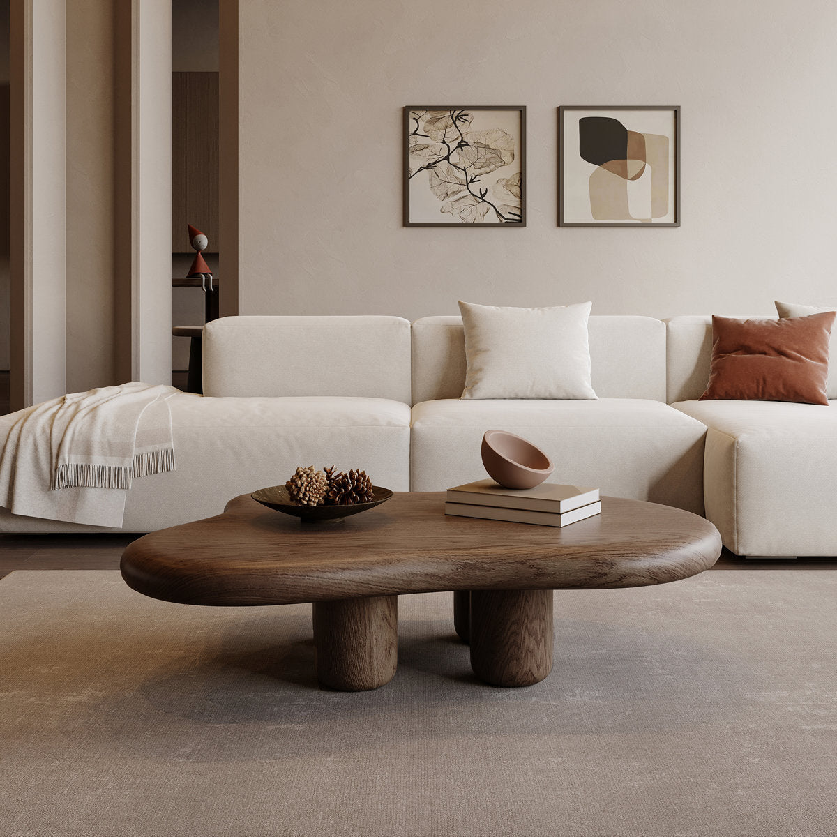 Modern living room with a white sofa, wooden coffee table, and abstract art on the wall.
