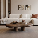 Modern living room with a white sofa, wooden coffee table, and abstract art on the wall.