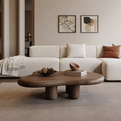 Modern living room with a white sofa, wooden coffee table, and abstract art on the wall.