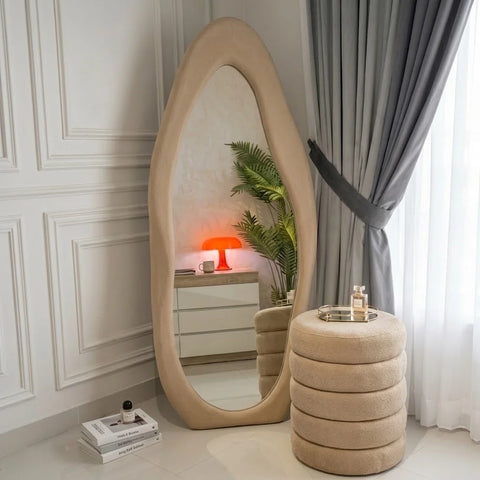 Beige ripple wavy mirror and ottoman by Zama Home Store in a modern interior setting