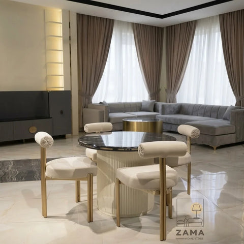 Black marble round dining table with cream boucle chairs in a luxury living room setting