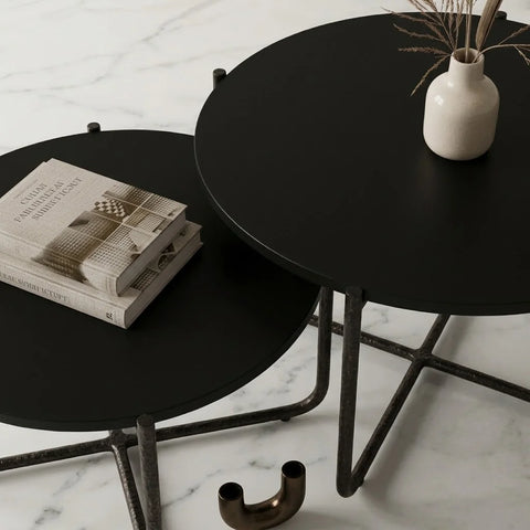 Close-up of the black metal frame and round top of Zama Home Store nesting tables