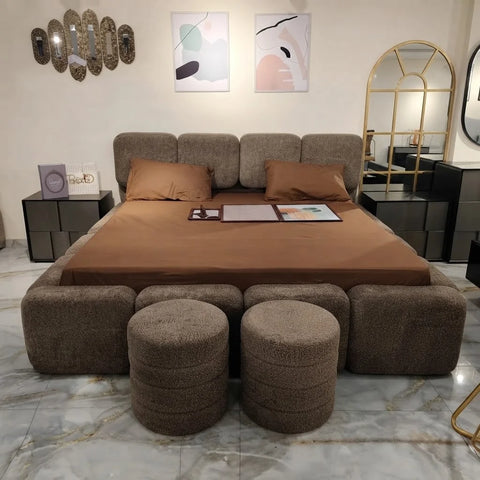 Front view of Bob boucle bed by Zama Home Store with matching ottomans in a showroom