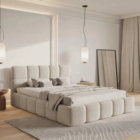 Angled view of Zama Home Store Gloria boucle bed in a warm room with pendant lights