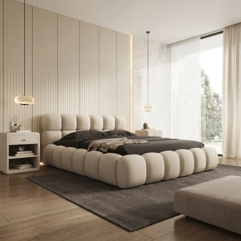 Romio boucle bed by Zama Home Store in a modern bedroom with ottoman and side tables