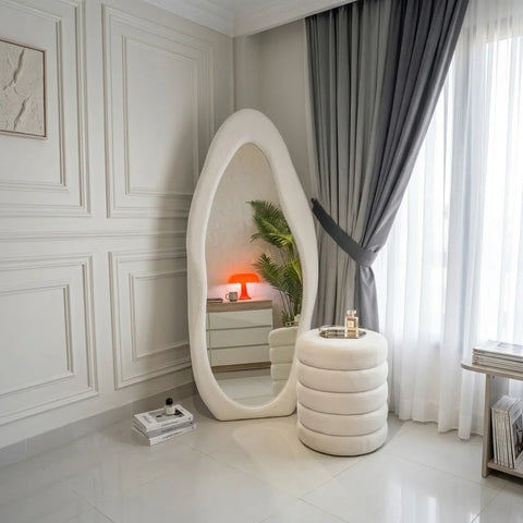 White ripple wavy mirror and ottoman by Zama Home Store in a luxury room with curtains